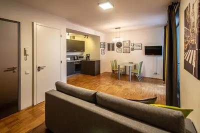 a living room with a couch and a table at Modern Apartment With Balcony and Garage in Prague