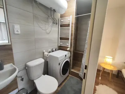 a small bathroom with a toilet and a sink at Kralovak in Králŭv Dvŭr
