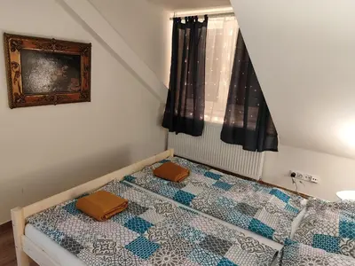 a bedroom with a bed with two cushions on it at Kralovak in Králŭv Dvŭr