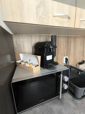 a microwave oven with a box on top of it at Kralovak in Králŭv Dvŭr