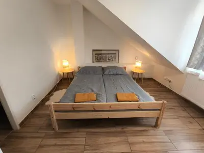 a large bed in a room with two lamps at Kralovak in Králŭv Dvŭr