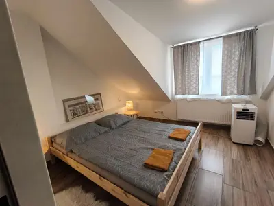 a bedroom with a bed with two towels on it at Kralovak in Králŭv Dvŭr