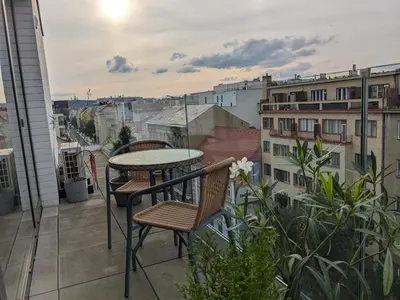 a balcony with a table and chairs and a view at Cozy Apartment with Big Terrace in Central Prague - Karlín in Prague