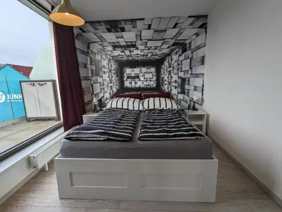 a bed in a room with a brick wall at Cozy Apartment with Big Terrace in Central Prague - Karlín in Prague