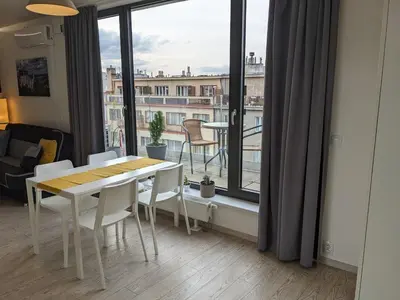 a room with a table and chairs and a large window at Cozy Apartment with Big Terrace in Central Prague - Karlín in Prague