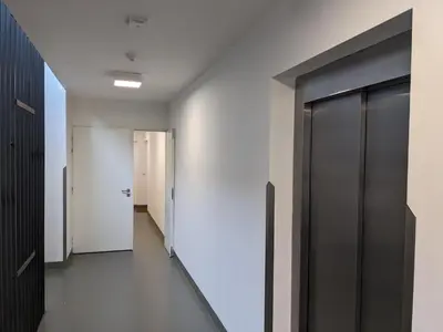a hallway with white walls and glass doors at Cozy Apartment with Big Terrace in Central Prague - Karlín in Prague