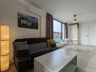 a living room with a couch and a table at Cozy Apartment with Big Terrace in Central Prague - Karlín in Prague