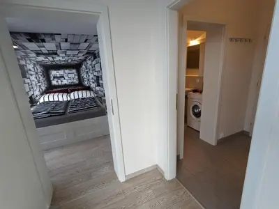 a hallway leading to a bedroom with a bed at Cozy Apartment with Big Terrace in Central Prague - Karlín in Prague