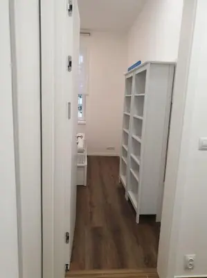 a hallway with white walls and a wooden floor at Prague Downtown Vinohrady - next to Havlícek Park in Prague