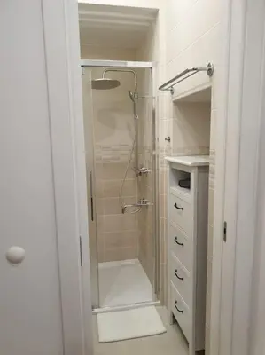 a bathroom with a shower with a glass door at Prague Downtown Vinohrady - next to Havlícek Park in Prague