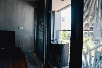 a room with a large window with a view of a building at Prague Marina River View Apartment Close To City Centre FREE PARKING in Prague
