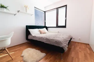 a bedroom with a bed and a window at Prague Marina River View Apartment Close To City Centre FREE PARKING in Prague