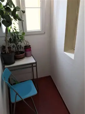 a blue chair next to a table with potted plants at Byt v srdci Žižkova Praha 3 in Prague