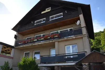 a building with balconies and flowers on it at Penzion Panorama in Beroun