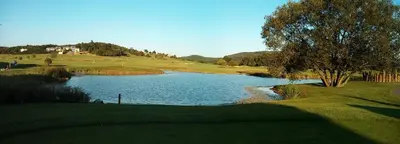a view of a golf course with a pond of water at Penzion Panorama in Beroun
