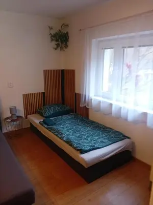 a small bed in a room with a window at Rekreační chata Kocába in Štěchovice