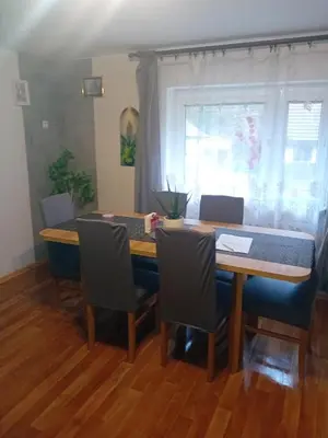 a dining room table with chairs and a wooden table at Rekreační chata Kocába in Štěchovice