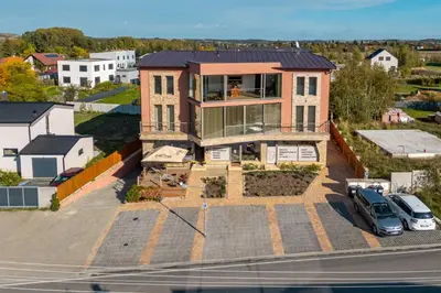 an aerial view of a house with a parking lot at LASKARA Garden Apartment by Prague Forest in Nové Jirny