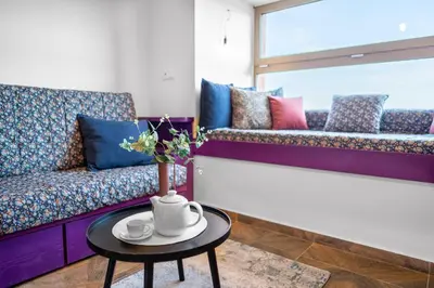 a living room with a couch and a table at LASKARA Garden Apartment by Prague Forest in Nové Jirny