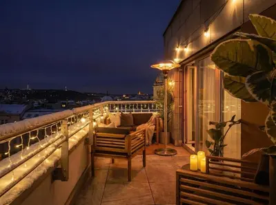 a balcony with a view of a city at night at TurnKey I Central Apartment with Terrace in Prague