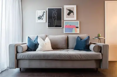 a living room with a gray couch with blue pillows at TurnKey I Central Apartment with Terrace in Prague