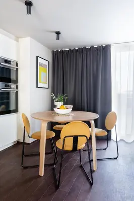 a dining room table with yellow chairs and a kitchen at TurnKey I Central Apartment with Terrace in Prague