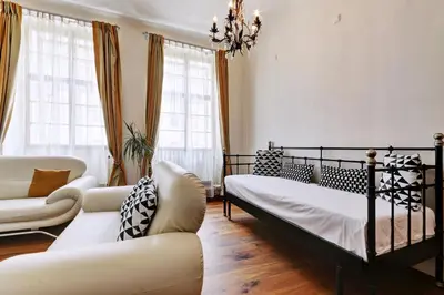 a bedroom with two beds and a couch at Historic Centre Apartments II in Prague