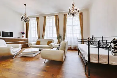 a large living room with a bed and chairs at Historic Centre Apartments II in Prague