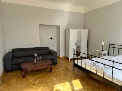 a living room with a couch and a bed at Historic Centre Apartments IV in Prague