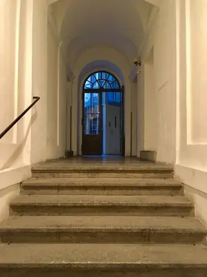 an empty hallway with stairs leading to a door at Historic Centre Apartments IV in Prague