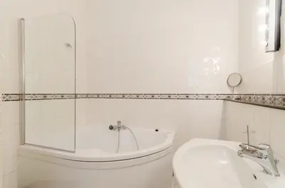 a bathroom with a tub and a toilet and a sink at Historic Centre Apartments IV in Prague