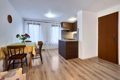 a kitchen and dining room with a table and chairs at Apartmány Kateřina in Ricany