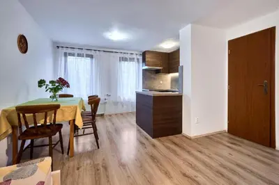 a kitchen and dining room with a table and chairs at Apartmány Kateřina in Ricany