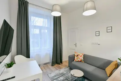 a living room with a couch and a window at Kubelíkova 32 Residence in Prague