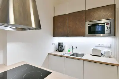 a kitchen with a sink and a microwave at Kubelíkova 32 Residence in Prague