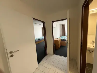a bathroom with a door leading to a bedroom at Hotel a ubytovna Zimní stadion Slaný in Slaný