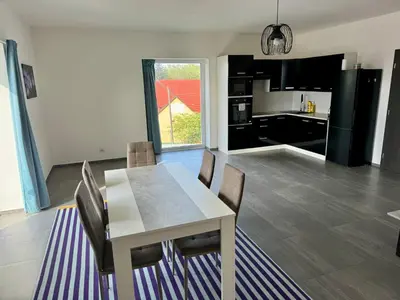 a kitchen and dining room with a table and chairs at Byt apartman 74m2 vyhled klid priroda in Prague