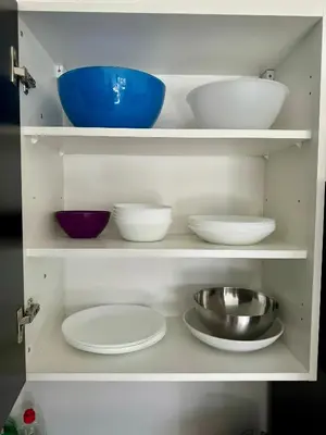 a white cabinet with bowls and plates in it at Byt apartman 74m2 vyhled klid priroda in Prague