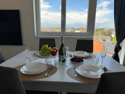 a table with a plate of fruit and a bottle of wine at Byt apartman 74m2 vyhled klid priroda in Prague
