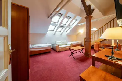 a kitchen with wooden cabinets and a sink at Hotel Raffaello Prague in Prague