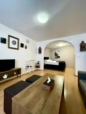 a living room with a bed and a couch at U Zeleného jalovce in Prague