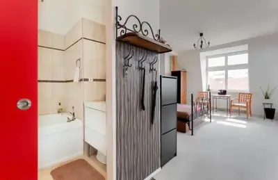 a kitchen with a refrigerator and a kitchen with a dining room at Lenka's cozy Red studio + Lenka's cozy Gold apartment in Prague