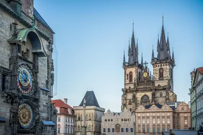 two towers of buildings with clocks on them at ModaLoft Duplex by Rentez in Prague
