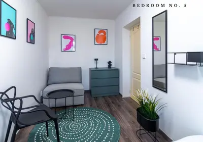 a room with a chair and a mirror at The Bookhouse, 5-bedroom residence by Prague Castle in Prague