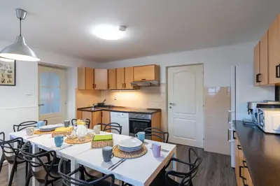 a kitchen with a table and chairs in a room at The Bookhouse, 5-bedroom residence by Prague Castle in Prague