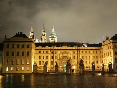 a large building at night with a building at The Bookhouse, 5-bedroom residence by Prague Castle in Prague