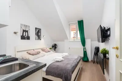 a kitchen with a sink and a bed in a room at Private Retreat Close to Stations in Praha 3 in Prague