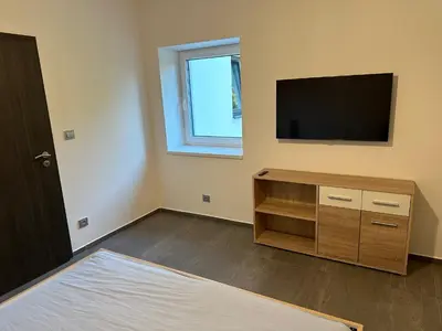 a room with a flat screen tv on the wall at Byt apartman 73m2 Klid příroda Parking FREE in Prague