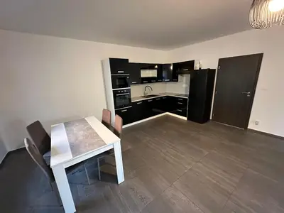 a kitchen with a table and a white table and chairs at Byt apartman 73m2 Klid příroda Parking FREE in Prague