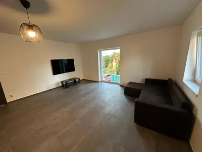 a living room with a couch and a flat screen tv at Byt apartman 73m2 Klid příroda Parking FREE in Prague
